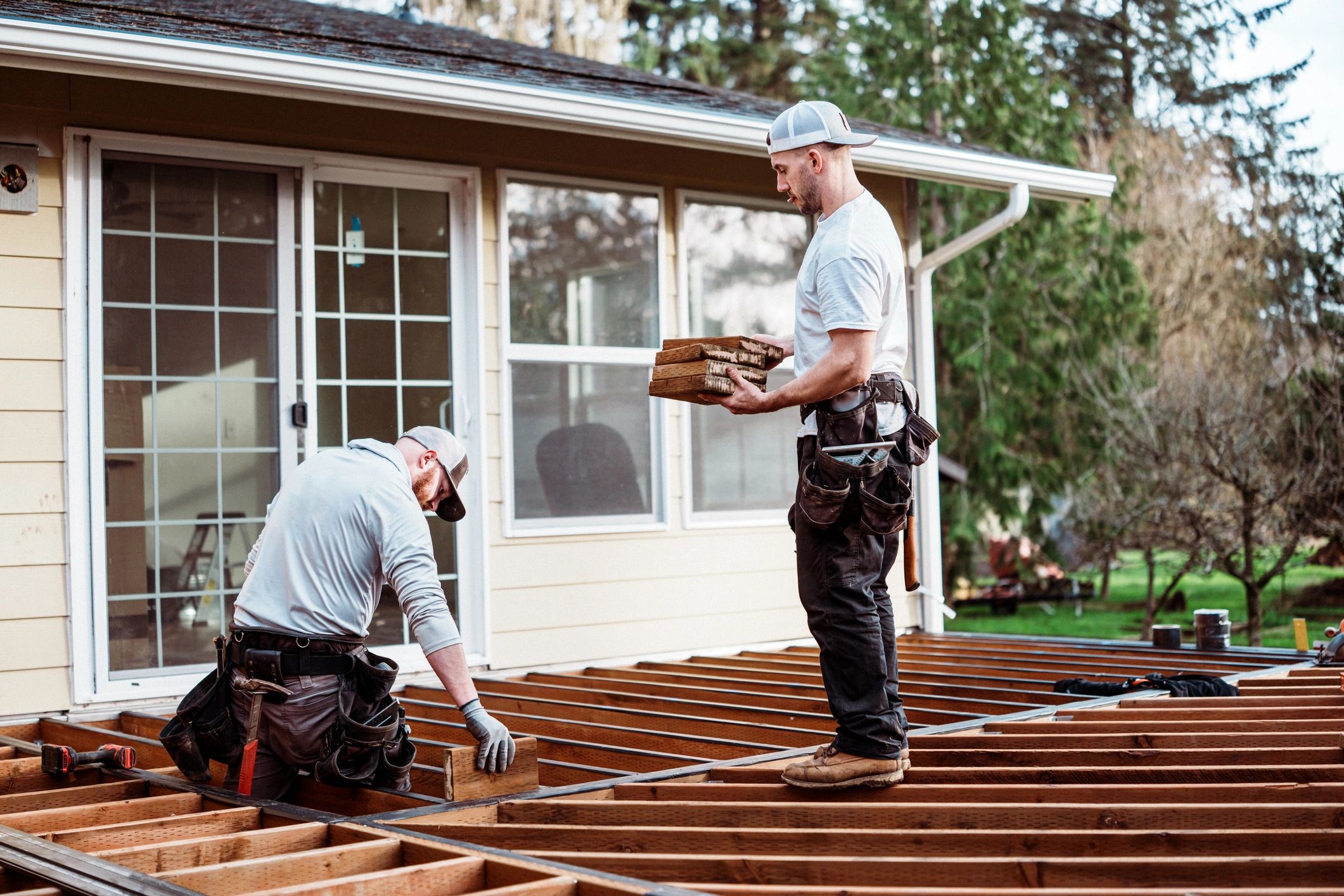 Contractors working on residential deck framing